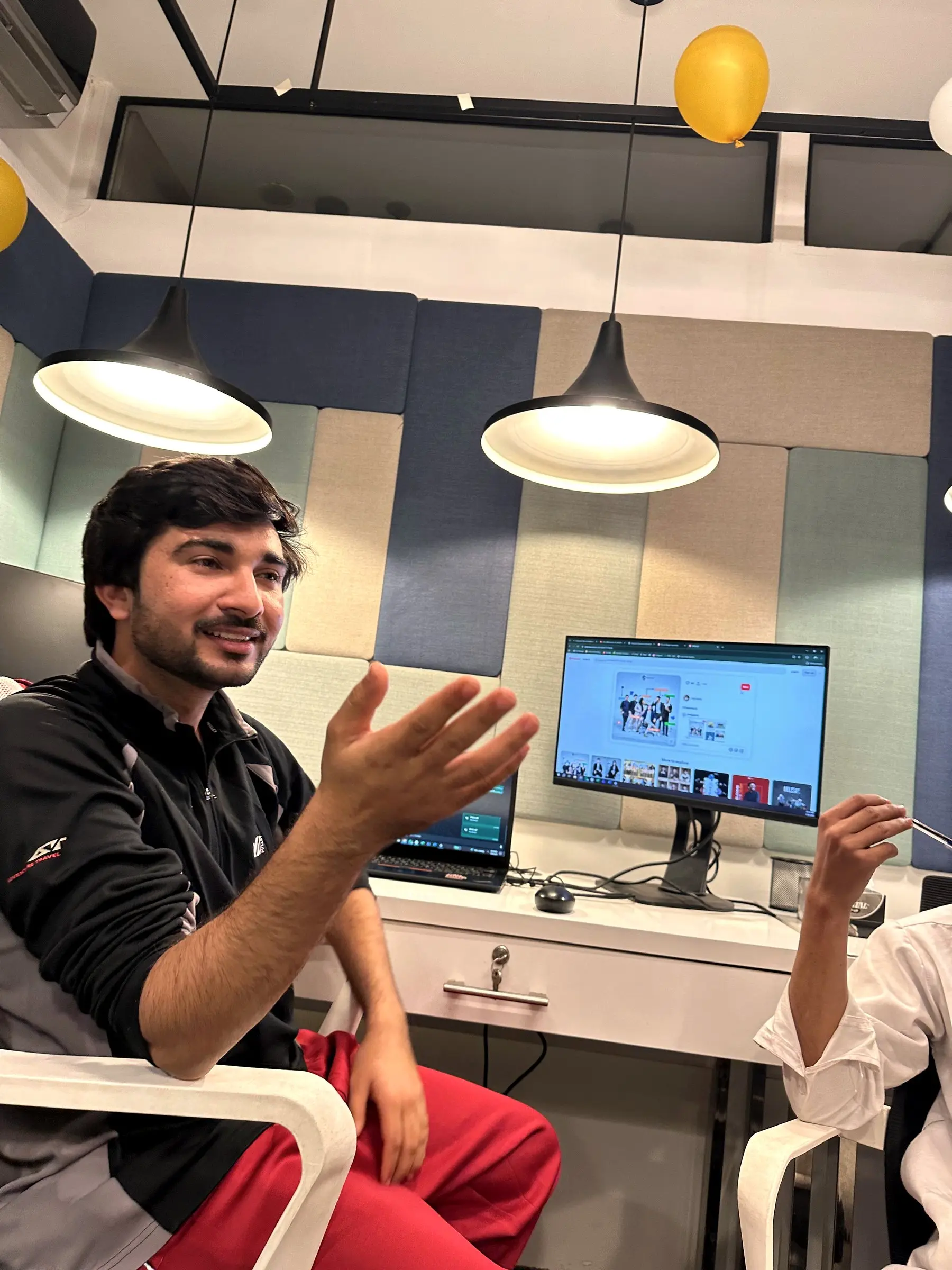 An engineer explaining an idea to a colleague at his desk