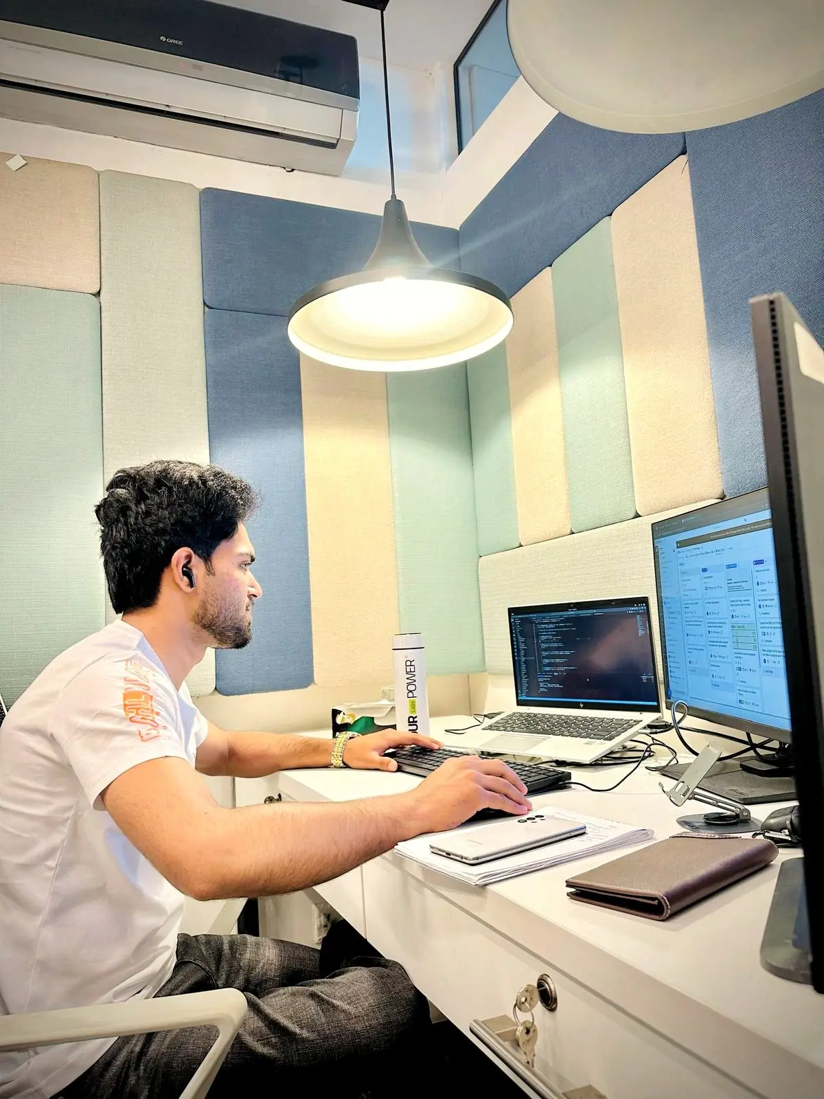 An engineer working across two monitors