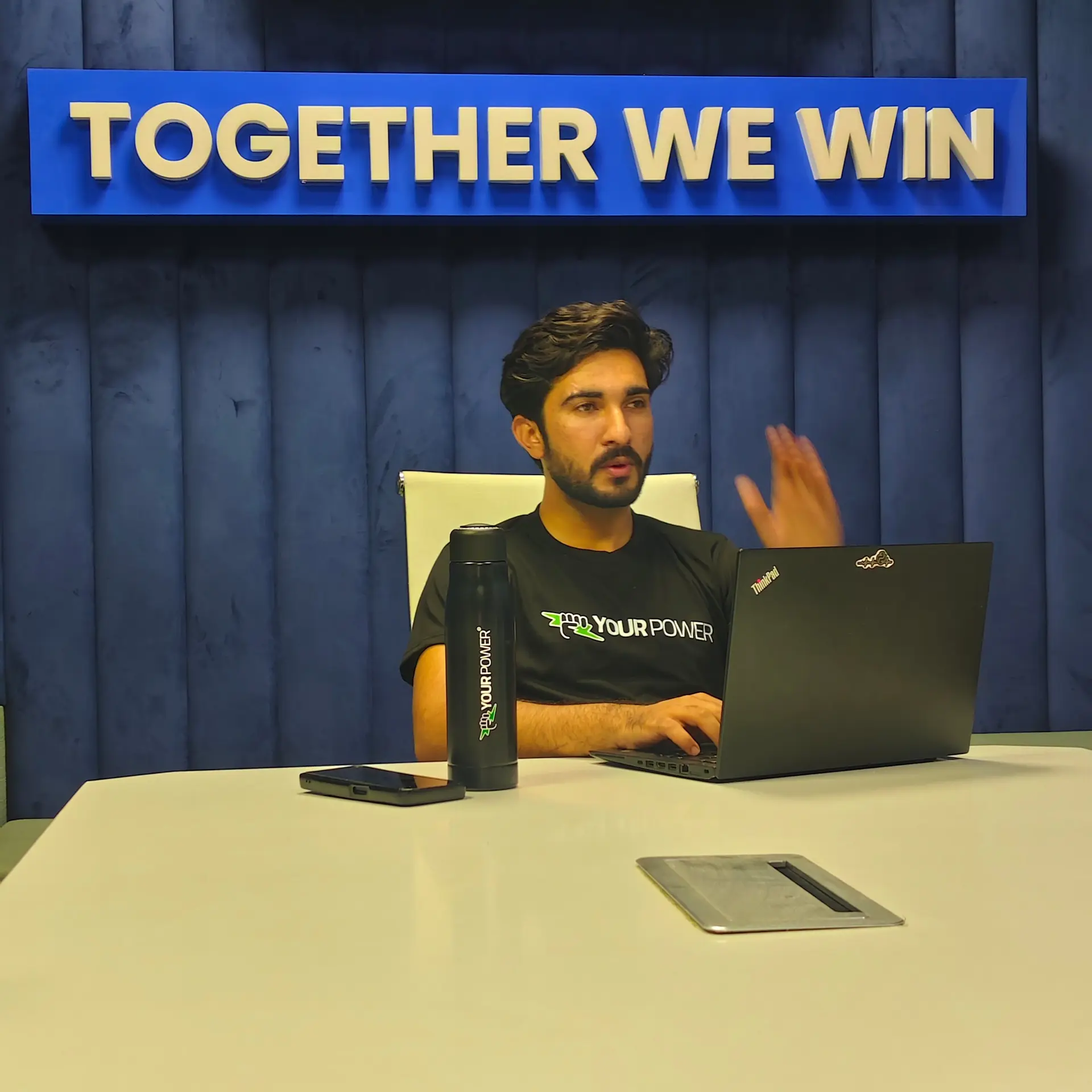 An engineer at work in front of the Together We Win sign