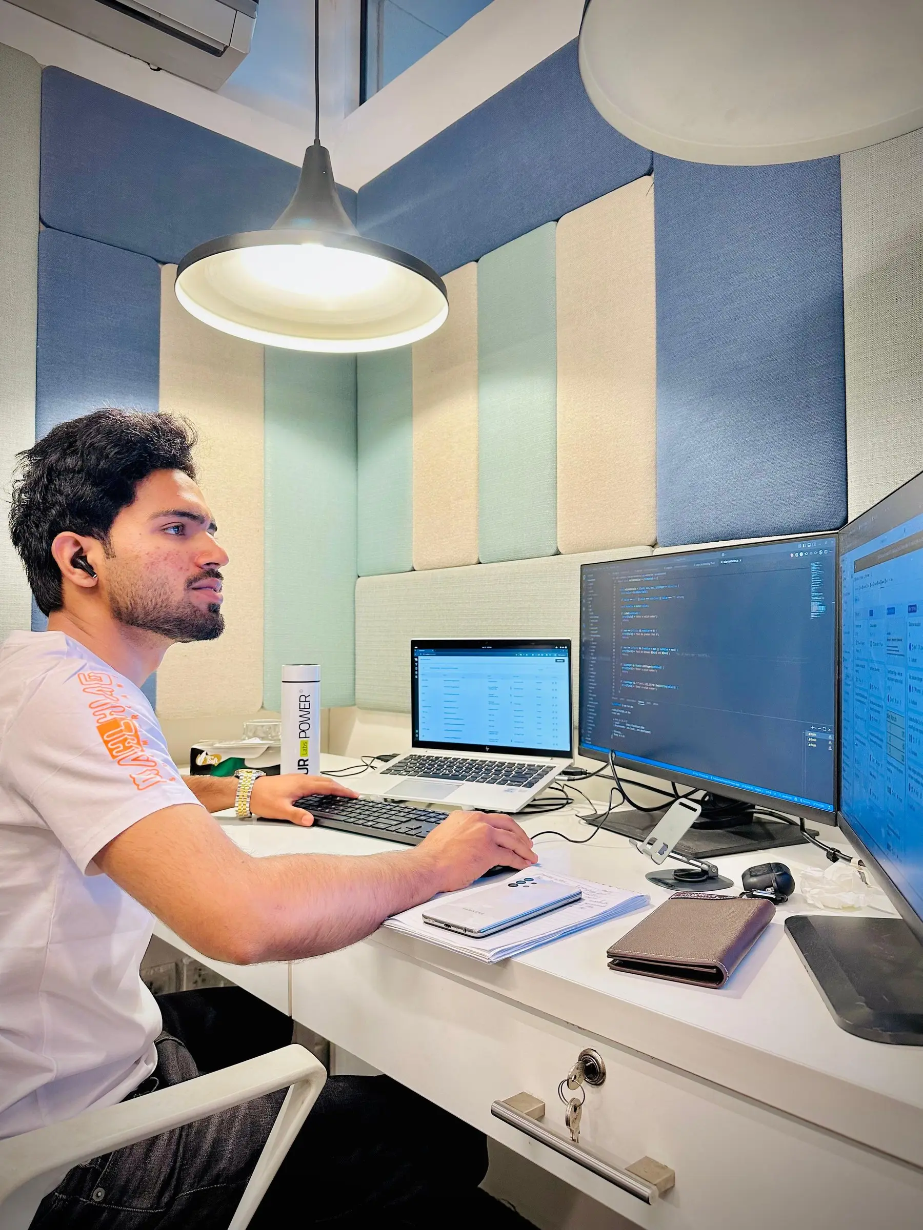 An engineer coding across two monitors