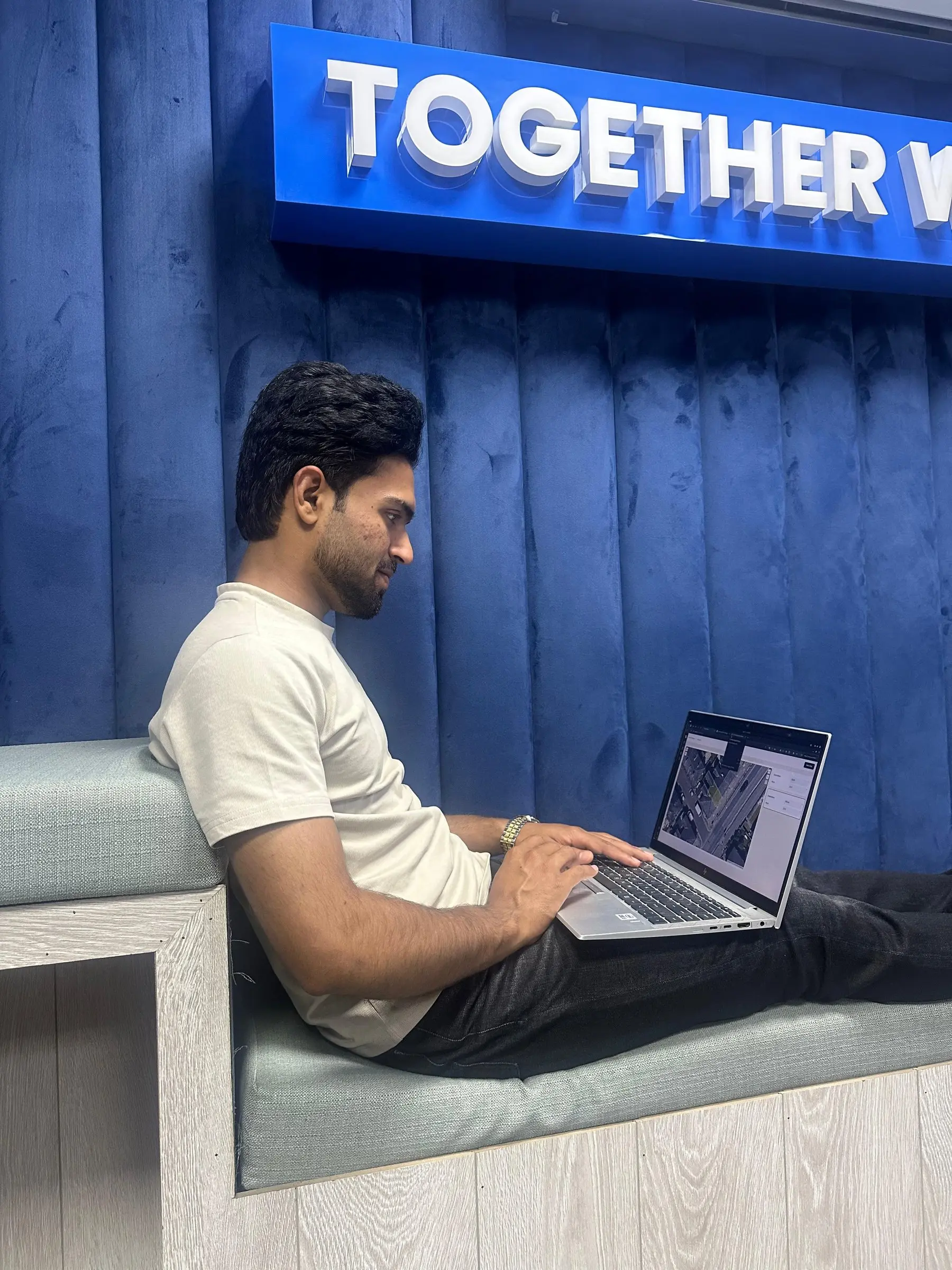 An engineer working on a laptop from the lounge