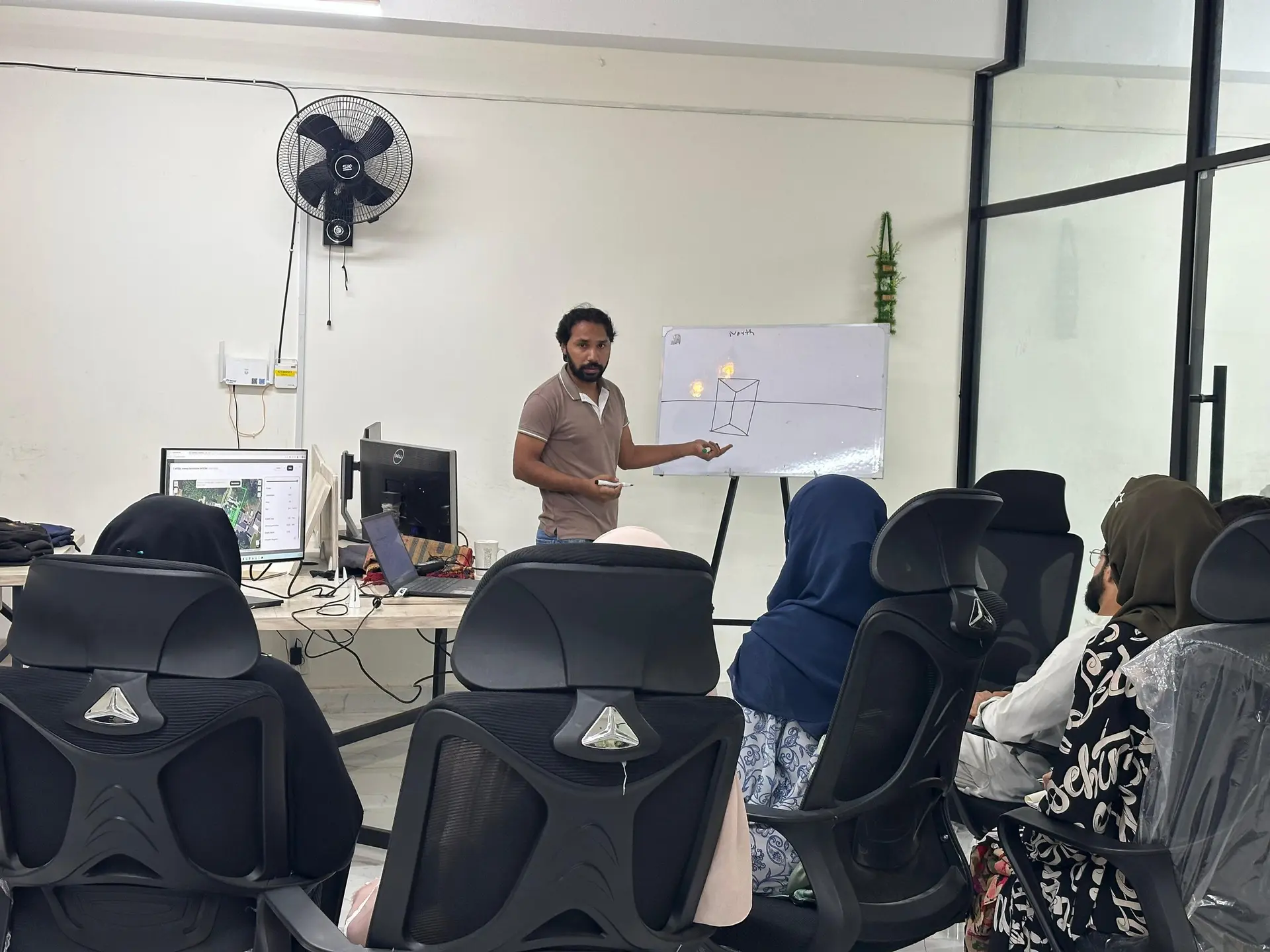 An engineer teaching at the whiteboard